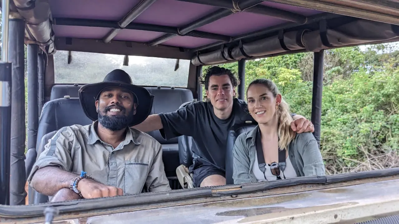 Expert guide leading a wildlife safari jeep tour in Sri Lanka's national park, spotting leopards and elephants